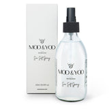 A clear spray bottle labeled 'MOO & YOO Sea Salt Spray' next to its packaging box.