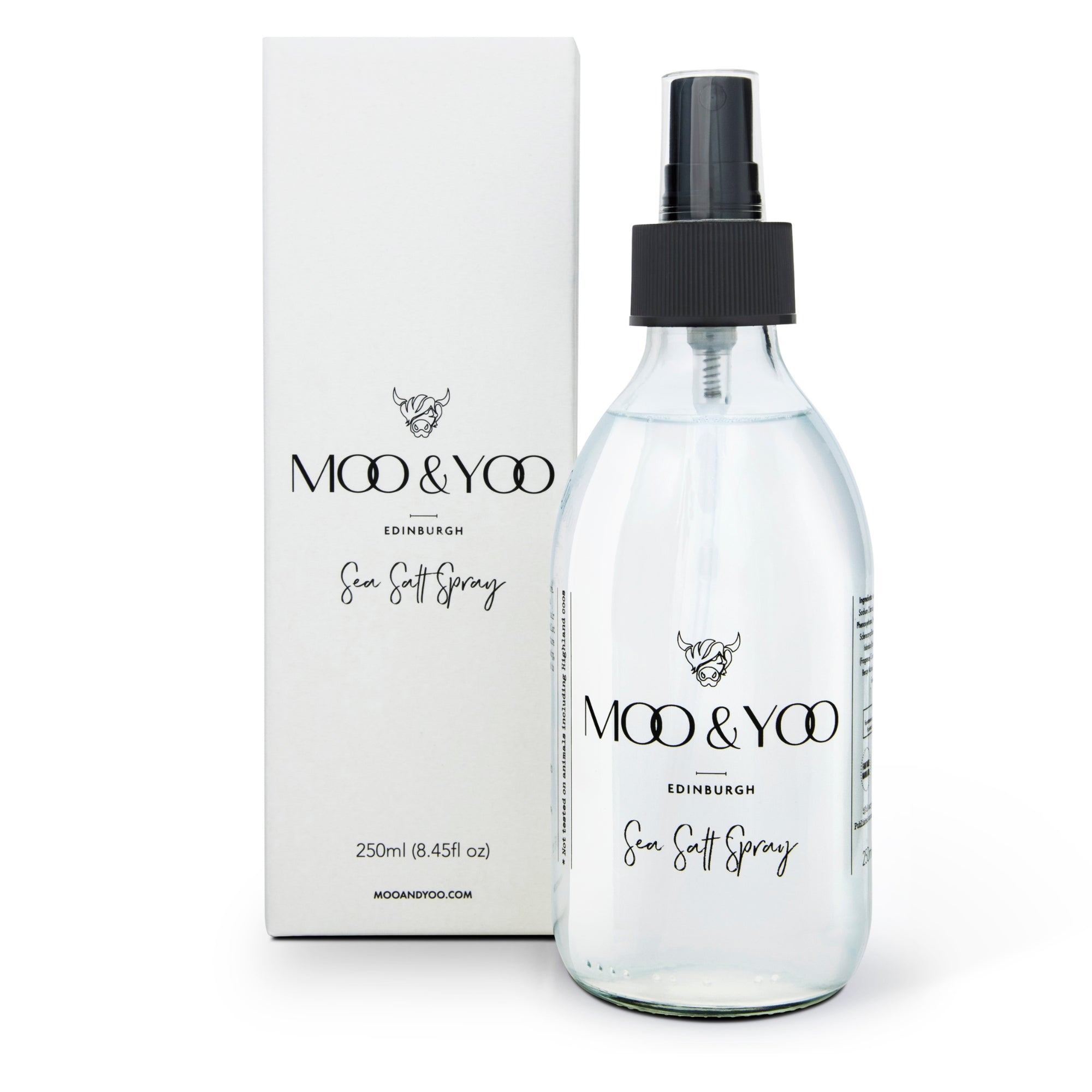 A clear spray bottle labeled 'MOO & YOO Sea Salt Spray' next to its packaging box.