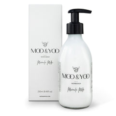A pump bottle of MOO & YOO Miracle Milk leave-in conditioner and heat protection, displayed alongside its packaging box.