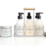 studio photo of moo & yoo product carrier caddy crate with bottled moo & yoo products in the crate ansd a jar of miracle mask to the left of the caddy. There is a white background and pieces of moss at the side of the products