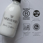 Bottle of Moo & Yoo Miracle Conditioner with certification logos on a gray background