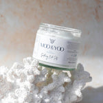 Jar of MOO & YOO bath salts on a bit of coral