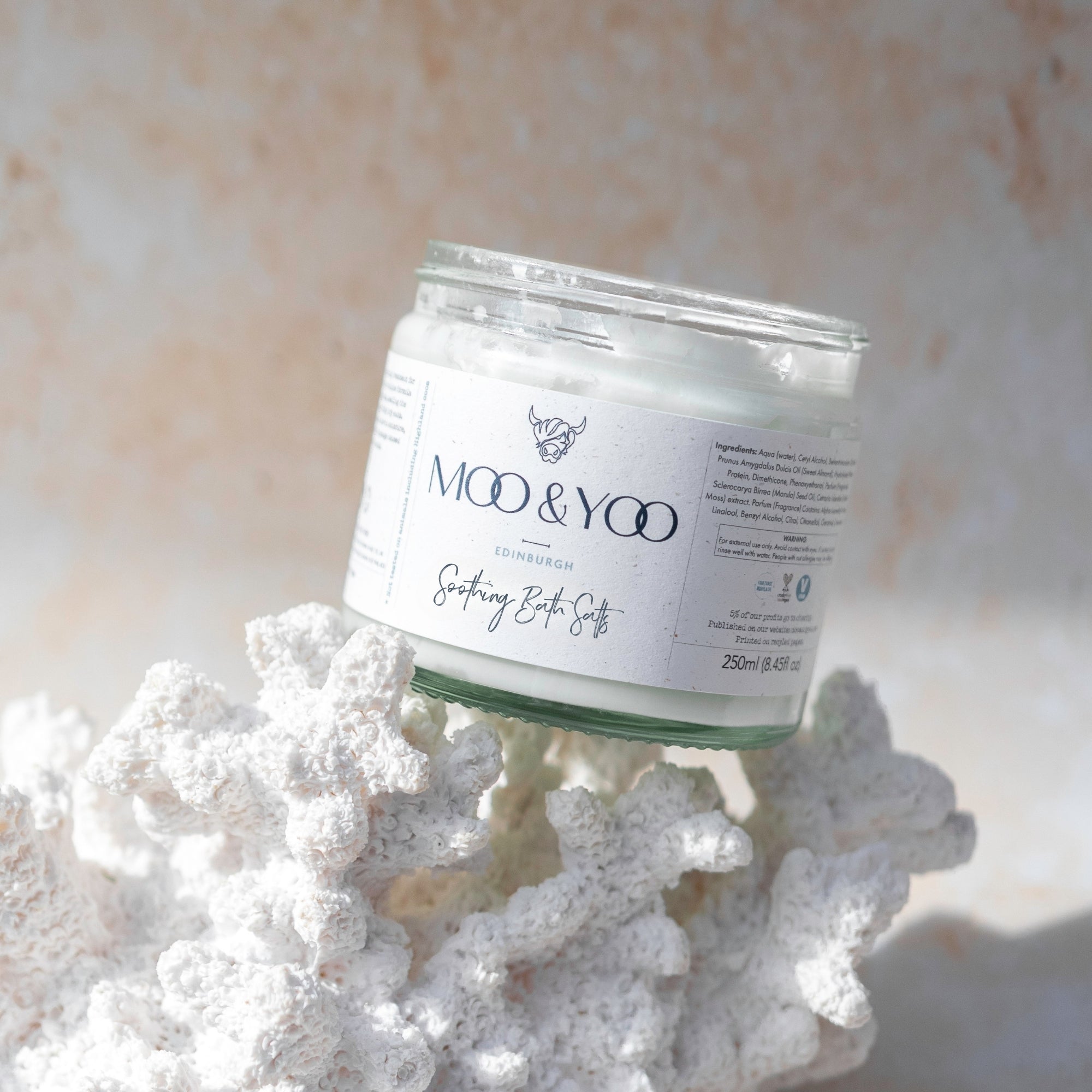 Jar of MOO & YOO bath salts on a bit of coral