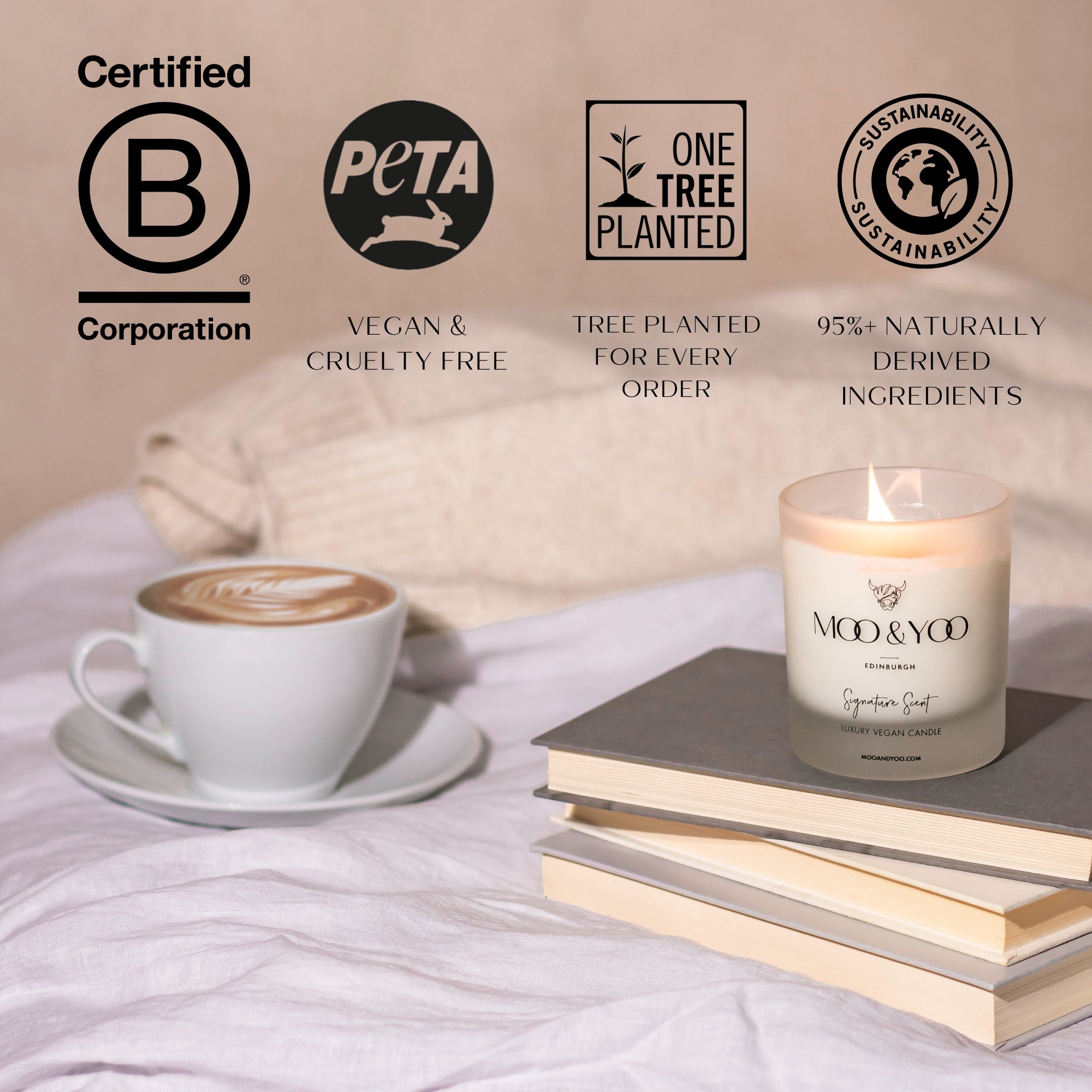 Candle and coffee on a bed with sustainability certification logos displayed.