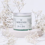 Moo & Yoo Miracle Mask jar with baby's breath flowers on a white background