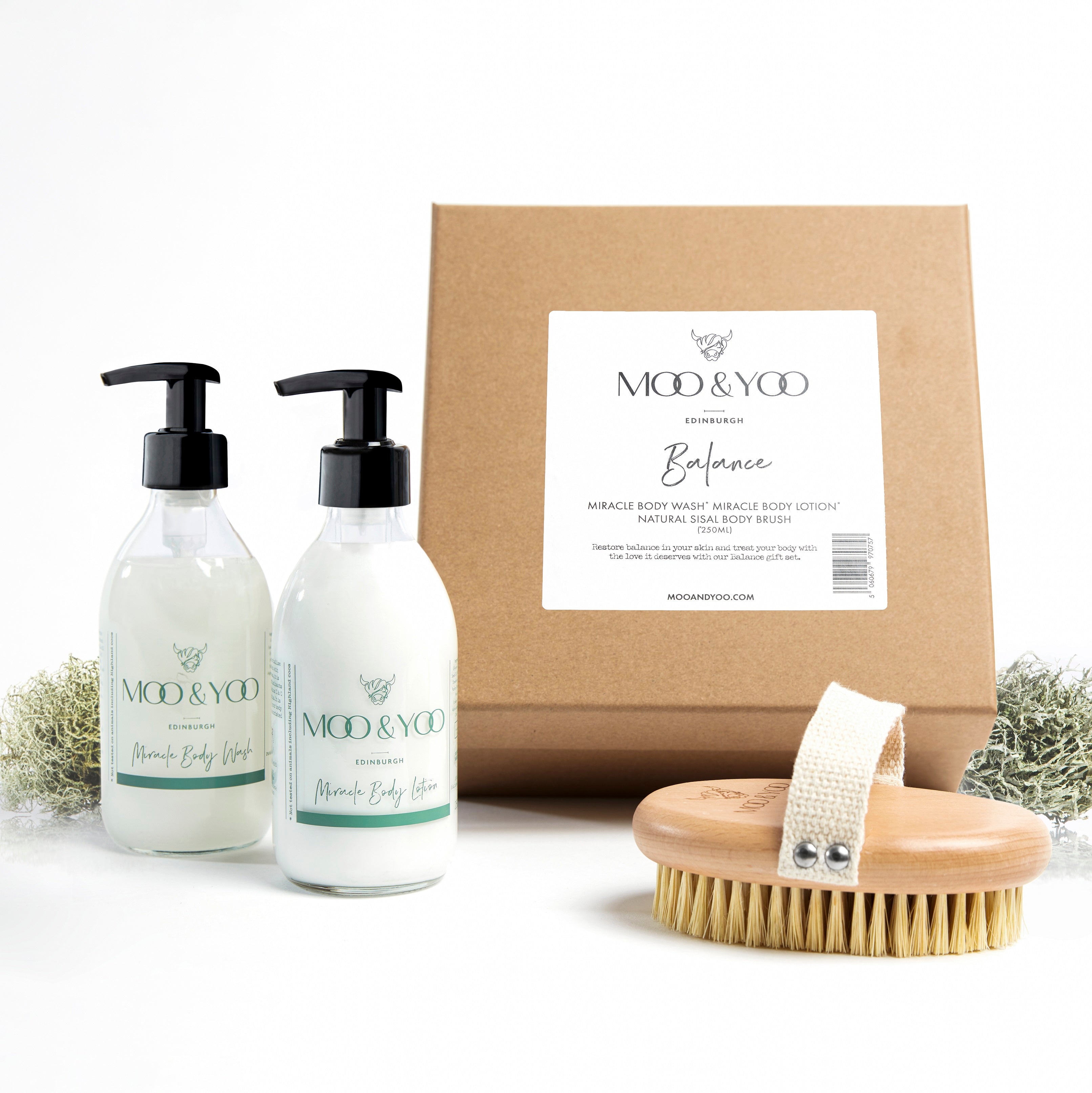 Image of a Kraft natural brown square gift box with label on the front displaying the gift box name which is Balance. The contents of the box are in front of it, Miracle Body Lotion, Body Wash and Sisal Body Brush.