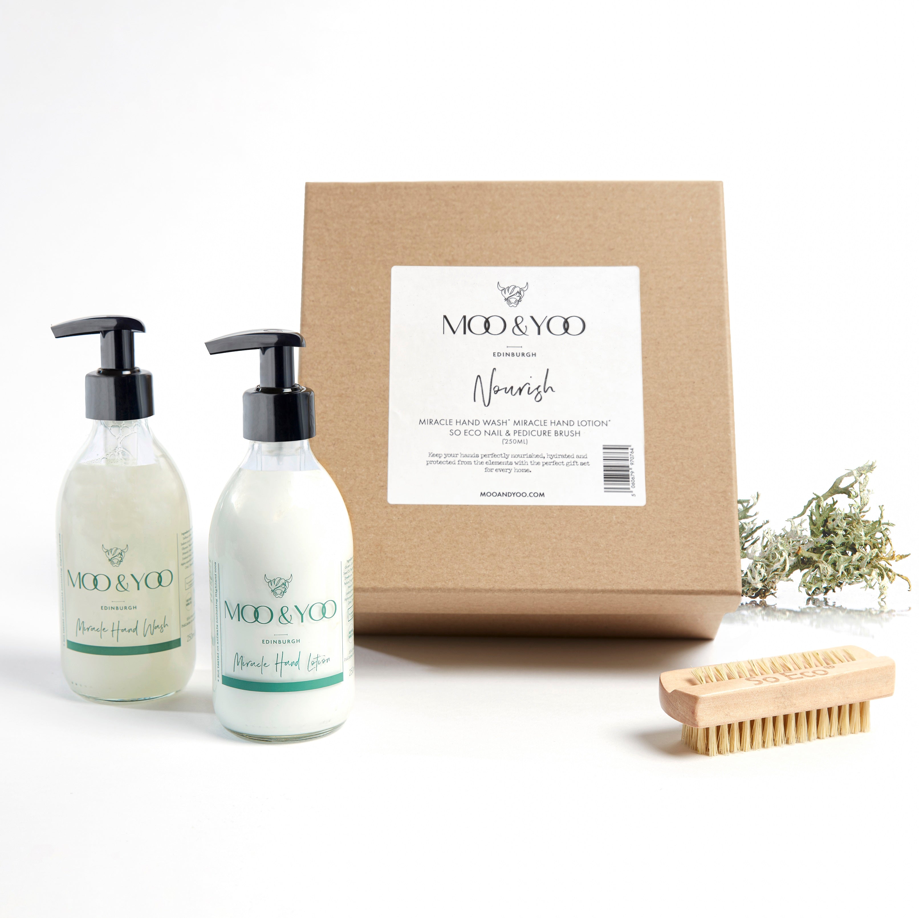 Image of a Kraft natural brown square gift box with label on the front displaying the gift box name which is Nourish. The contents of the box are in front of it, Miracle Hand Wash, Hand Lotion and nail brush.
