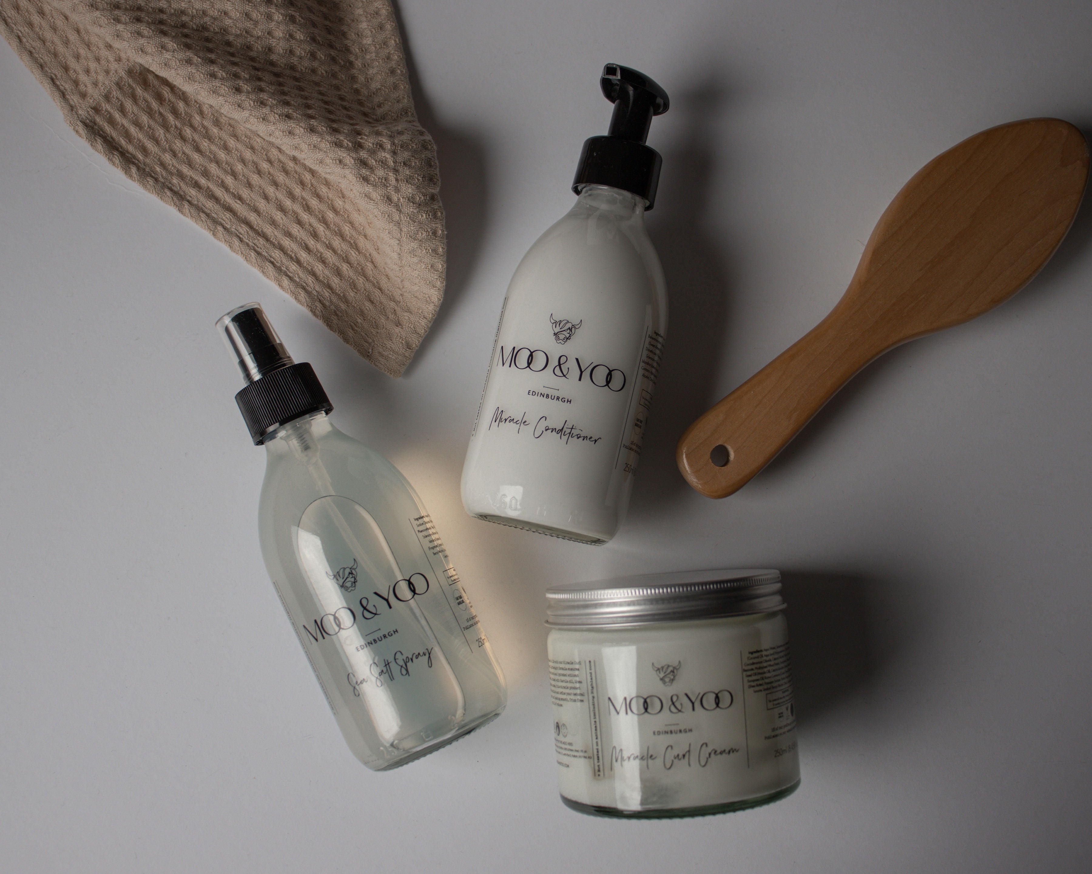 Minimalist zero-waste hair care options laid out for comparison with traditional plastic-heavy products.