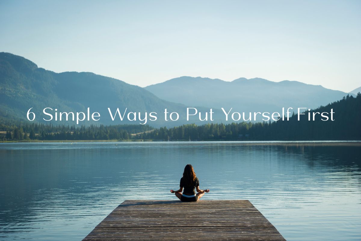 A women s sitting on a dock whilost doiong some yoga. She is looking out over a lake and some mountains. There is writing on thsi image that says "6 Simple Ways to Put Yourself First"
