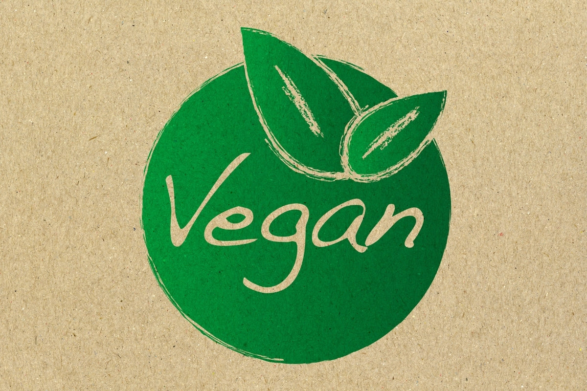 A plain brown background with a green vegan logo in the centre of the image.