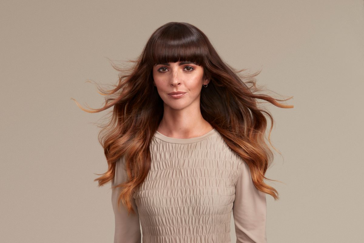 Studio shot of a female model with long bouncy curls.