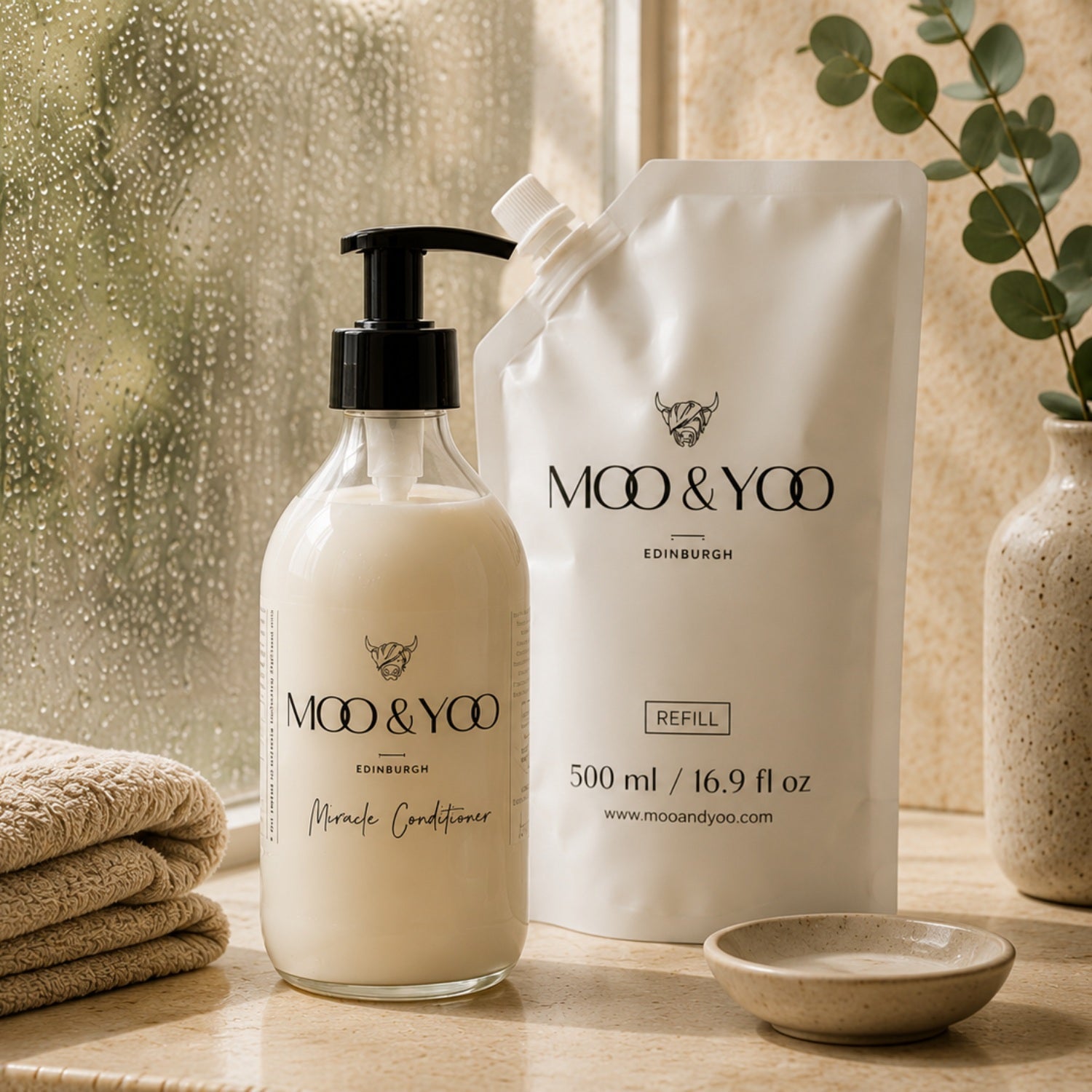 Moo & Yoo Miracle Conditioner and 500ml refill pouch displayed in a warm, natural bathroom setting.