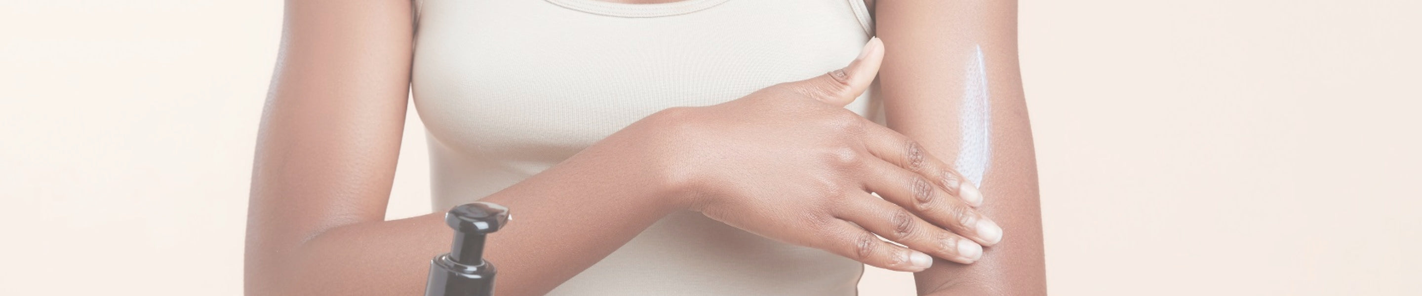 Person applying lotion to their arm with a focus on bodycare.