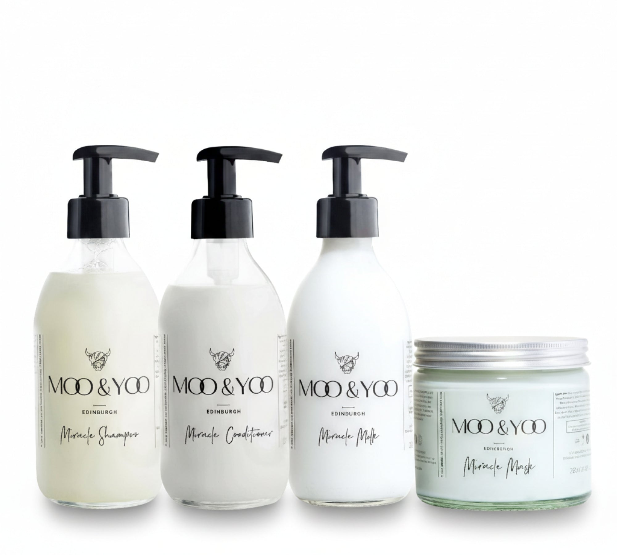 Three glass bottles and a glass jar of Moo and Yoo products sitting side by side. It is a Miracle Shampoo, Conditioner, Miracle Milk and a Miracle mask. They are on a white background.