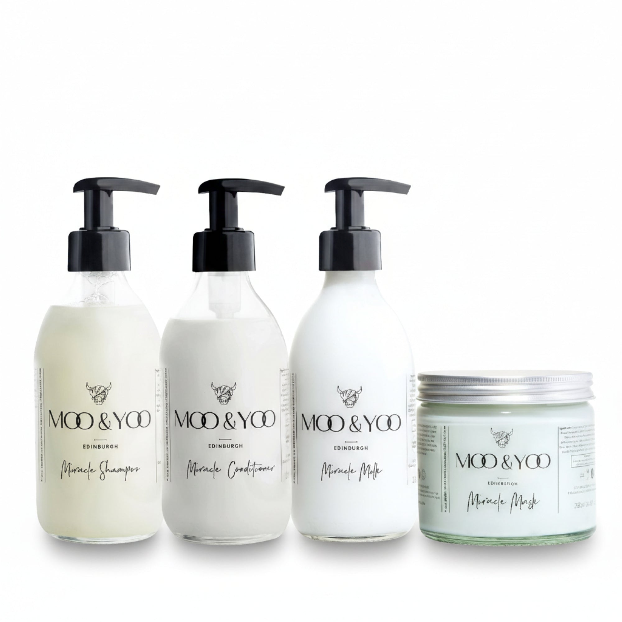 Three glass bottles and a glass jar of Moo and Yoo products sitting side by side. It is a Miracle Shampoo, Conditioner, Miracle Milk and a Miracle mask. They are on a white background.