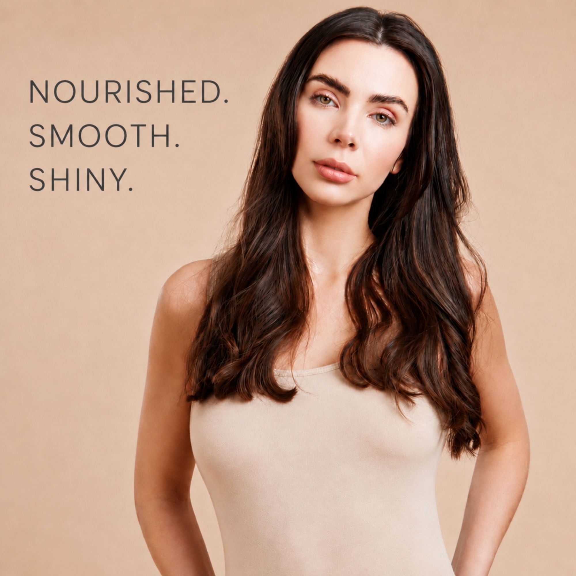 A woman with long, dark brown, glossy hair is shown against a warm beige background, wearing a beige tank top. The text on the left reads 'NOURISHED. SMOOTH. SHINY.