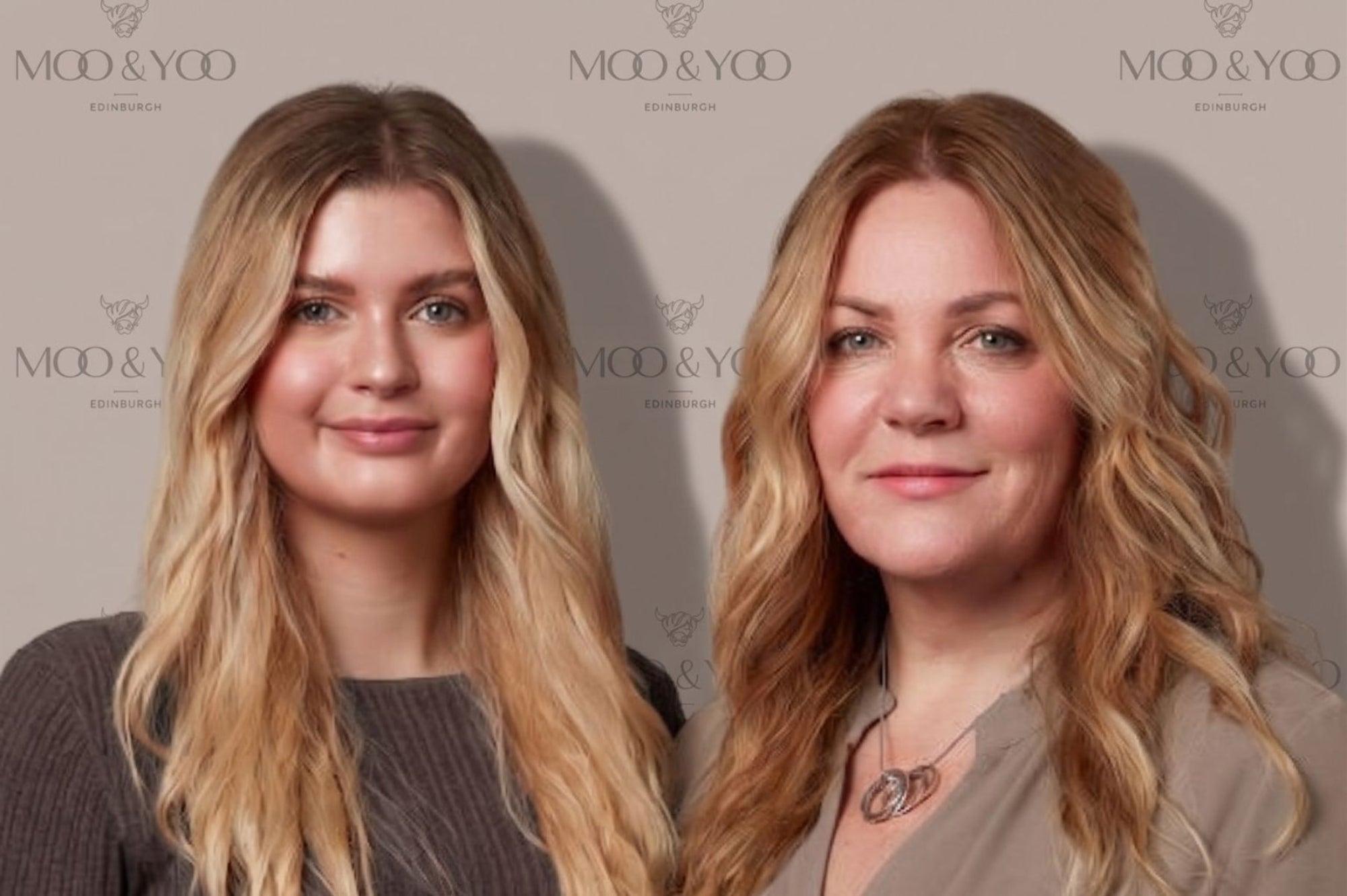 Two women with long blonde wavy hair standing side-by-side in front of a beige backdrop printed with the 'MOO & YOO' brand logo.