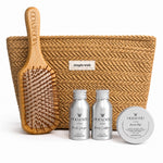 A hair care gift set from MOO & YOO featuring a natural woven pouch with a 'simple wish' label, a wooden paddle hairbrush engraved with the brand name, and three silver travel mini bottles and tins of haircare products in the front.