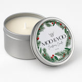metal circular tin of vegan christmas panettone scented candle with a white label and a wreath on the design 