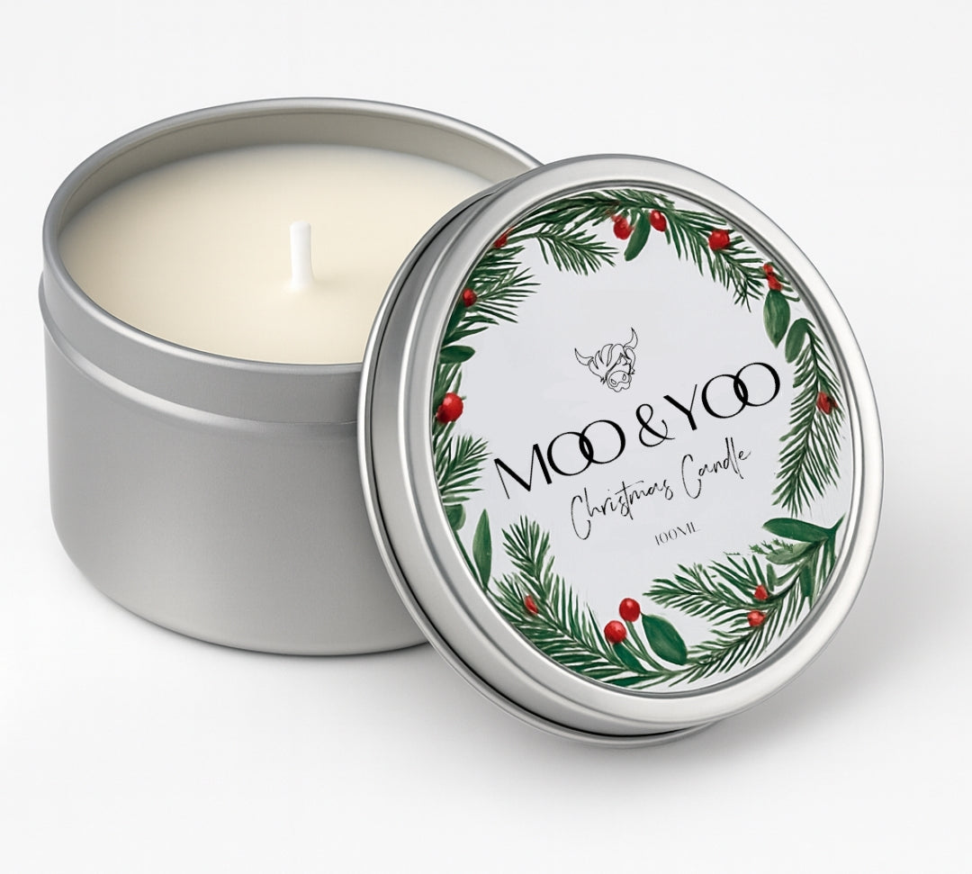 metal circular tin of vegan christmas panettone scented candle with a white label and a wreath on the design 