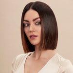Female model with a super straight brunette bob from using Moo and Yoo Miracle Conditioner and Mask. She has super shiny hair. She is looking at the camera and is wearing a neutral coloured blouse.