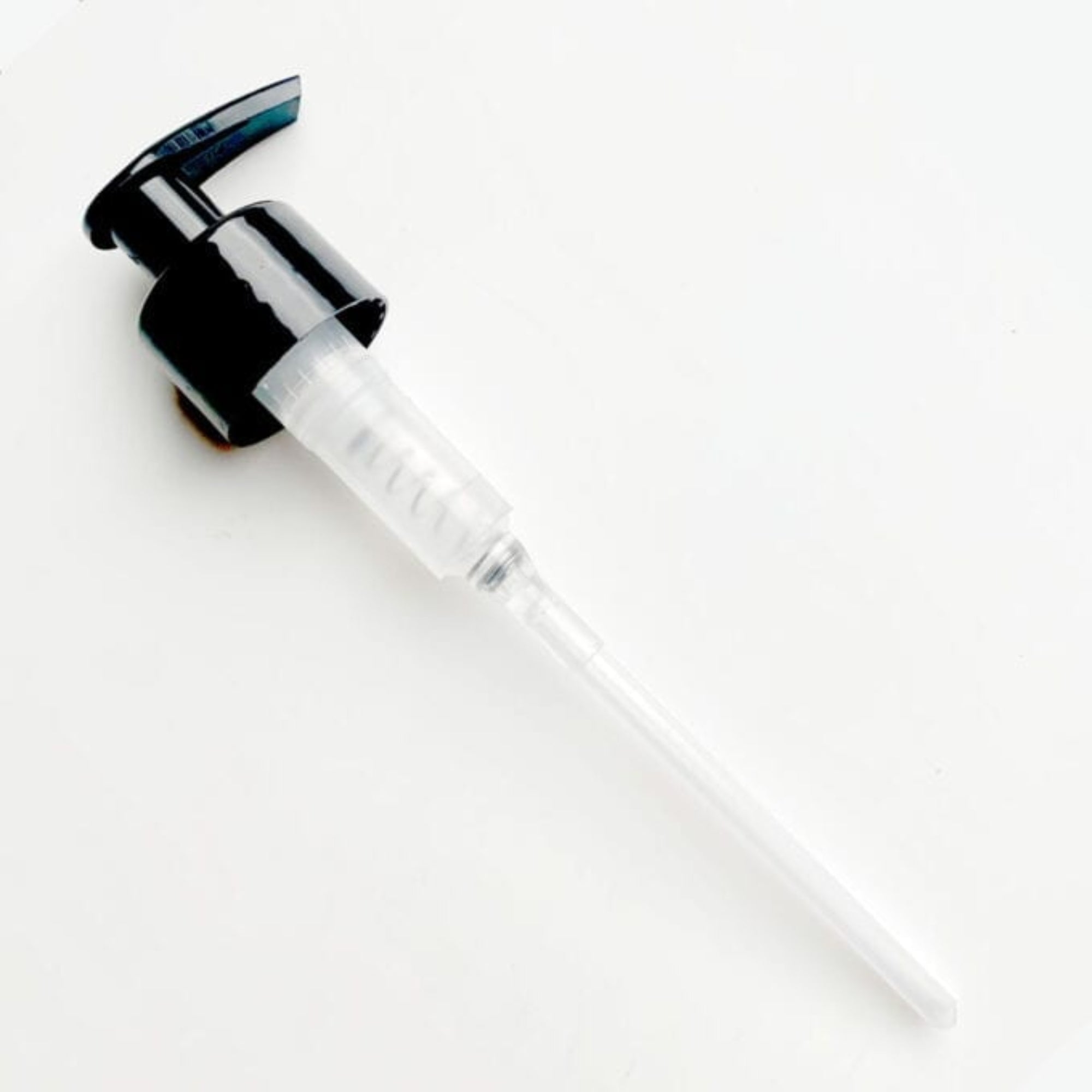 black pump dispenser on a white background