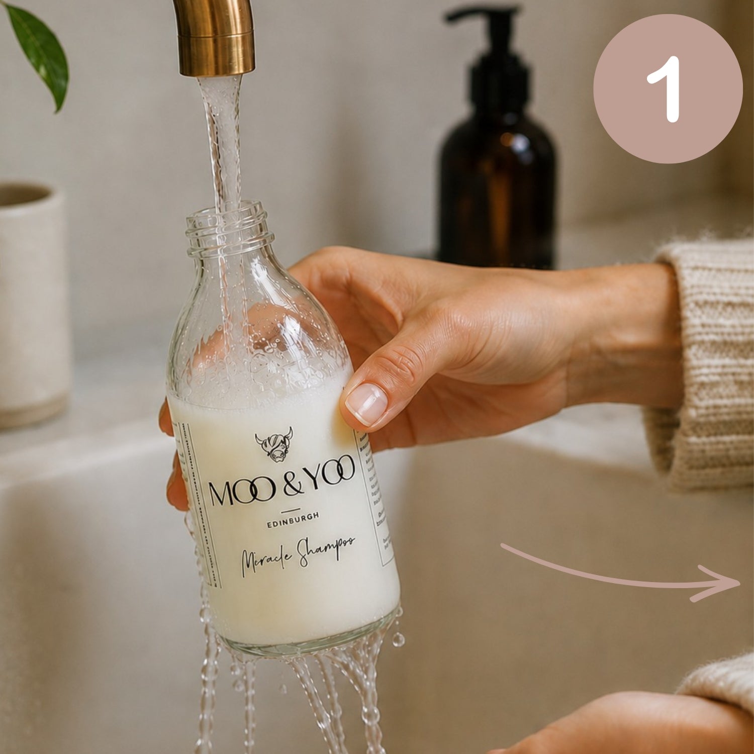 person cleaning out moo & yoo glass bottle at their sink ready to be recycled 