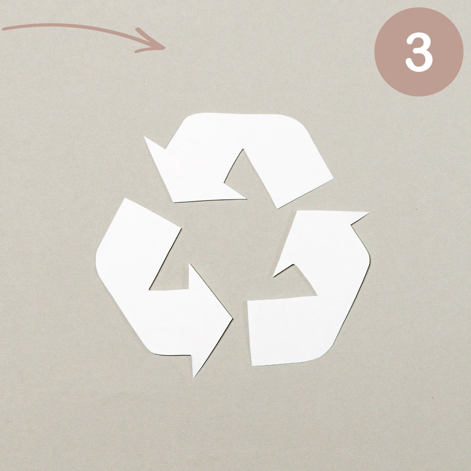 Recycling symbol on a beige background with a pink circle and number 3.