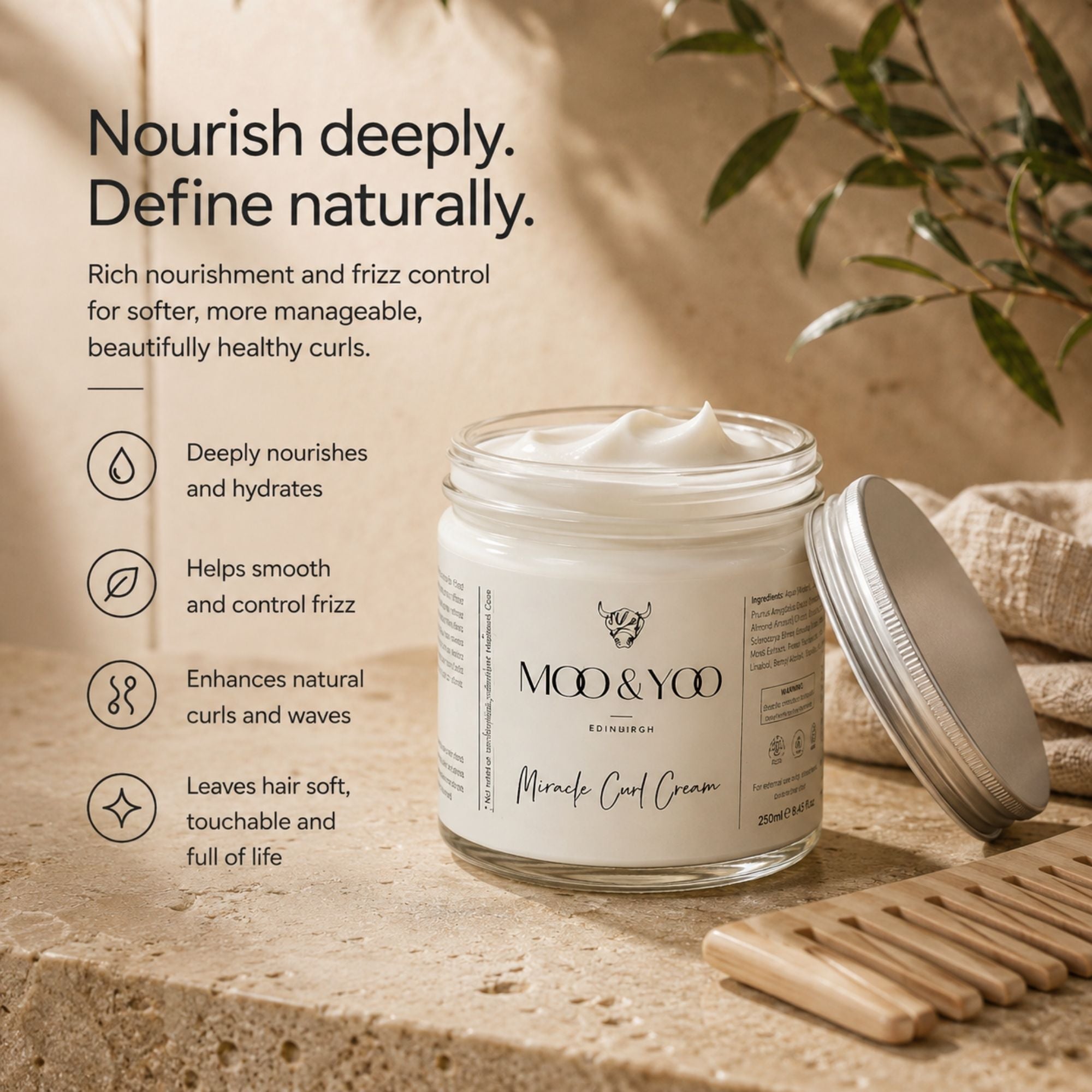 A jar of Moo & Yoo Miracle Curl Cream shown open with cream visible inside, alongside a metal lid, on a stone surface with decorative leaves and a wooden comb. Text on the left describes deep nourishment and curl definition.