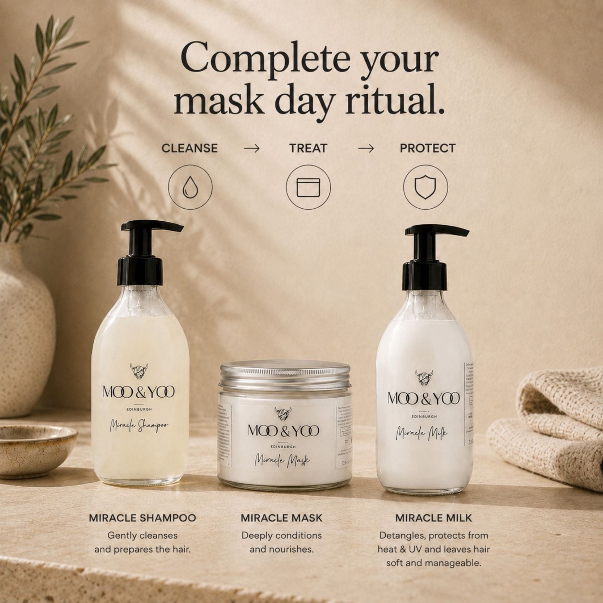 Three hair care products from MOD & YOO are displayed on a stone surface with a beige background and decorative props. The products are Miracle Shampoo in a frosted bottle, Miracle Mask in a glass jar with a silver lid, and Miracle Milk in a white pump bottle.
